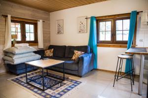 a living room with a couch and a table at Leśne Siedlisko in Józefów