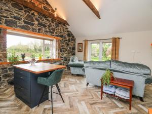 a living room with a stone wall at The Stable in Dublin