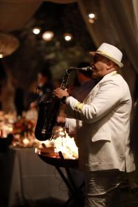 a man in a hat holding a saxophone at Bohemian lodge guest house in Aït Namous