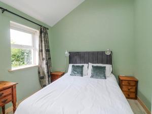 a bedroom with a large white bed with two pillows at The Stable in Dublin