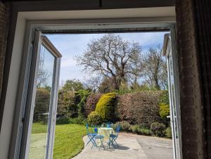 an open door with a table and chairs outside at The Stable in Dublin +9 photos