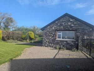 a stone house with a window in a yard at The Stable in Dublin