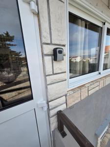a window on a brick wall next to a door at Apartment Vi & La ELECTRIC SCOOTERS included in Vir