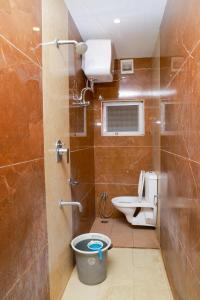 a bathroom with a toilet and a sink at Bhavan Resorts in Yercaud +159 photos
