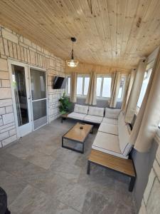 a living room with couches and a table at Apartment Vi & La ELECTRIC SCOOTERS included in Vir