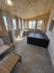 a room with a bed and a couch and windows at Apartment Vi & La ELECTRIC SCOOTERS included in Vir