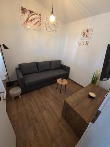 a living room with a couch and a table at Apartment Vi & La ELECTRIC SCOOTERS included in Vir