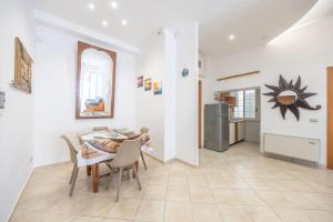 a kitchen and dining room with a table and chairs at Piazza Pia Suites in Anzio