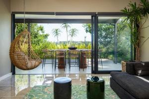 a living room with a table and chairs at The Pearl Ballito in Ballito