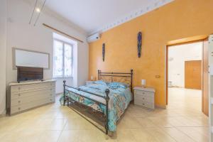 a bedroom with a bed and a flat screen tv at Piazza Pia Suites in Anzio