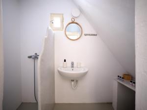 a white bathroom with a sink and a mirror at Flair Naousa in Naousa +18 photos