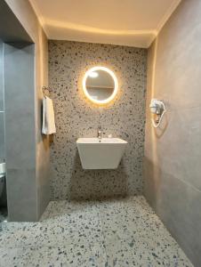 a bathroom with a sink and a mirror at Alicante Otel - Adult Only in Bozcaada