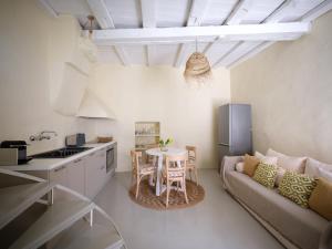 a kitchen and a living room with a couch and a table at Flair Naousa in Naousa