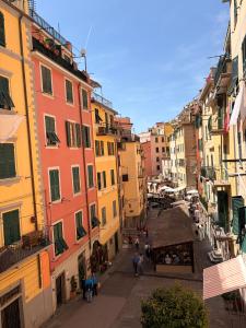 a group of people walking down a street with buildings at La Dolce Vita in Riomaggiore