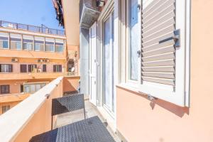 a balcony with a view of a building at Piazza Pia Suites in Anzio