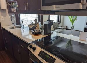 a kitchen with a stove and a counter top at Modern Downtown Loft Walk to Convention Center in Richmond