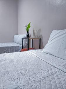 a bedroom with a white bed and a table at Rivera Solea in Llano de Los Patos