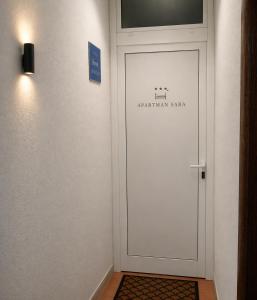 a white door in a room with a sign on it at Apartment Sara in Baška