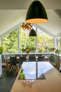 a dining room with a table and a large window at Fells in Chapel Stile