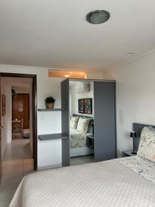 a bedroom with a bed and a mirror at APART HOTEL MANAIRA PALACe 2 in João Pessoa +21 photos