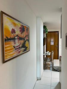 a painting of a boat on a wall in a hallway at APART HOTEL MANAIRA PALACe 2 in João Pessoa