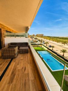 a view from the balcony of a building with a swimming pool at Claudia Luxury Apartment near the beach with a pool, gym, and secure gated parking in Arenales del Sol