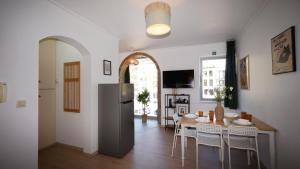 a kitchen and dining room with a table and a refrigerator at Anvers Apartment in Antwerp