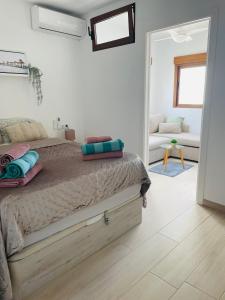 a bedroom with a bed with blue pillows on it at Hidden Gem Playa Flamenca Apartment with Pool View - Oleza Garden in Playa Flamenca +6 photos