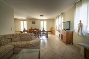 a living room with a couch and a dining room at Villa La Corte in Cesa