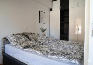 a large bed in a bedroom with a white wall at Petar Apartment-City Center, Ohrid in Ohrid