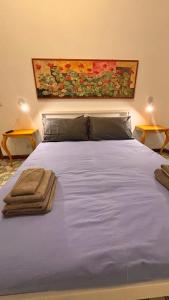 a bed with two pillows on top of it at A casa nostra in Formello