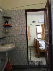 a bathroom with a sink and a bedroom with a bed at jayaram Home Palace Chittoor in Chittoor +135 photos