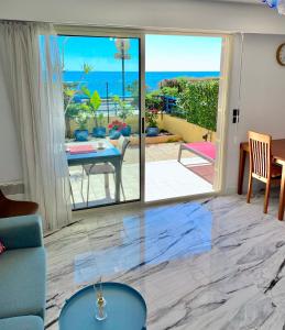 a living room with a view of the ocean at Beach and Sea View in Roquebrune-Cap-Martin