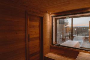 a room with a window and a bed on a balcony at Pousada Boutique Villa Valley in Praia do Rosa +37 photos