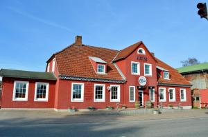 a red building on the corner of a street at Restaurant Ollex and beds Zimmer 4 in Bliesdorf
