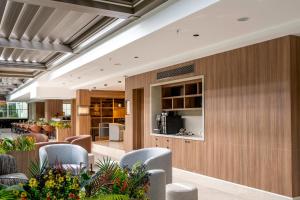 a lobby of a restaurant with chairs and tables at The Marni Hotel & Spa - Adults Only 12 Plus in Antalya