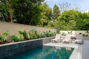 a patio with chairs and a swimming pool at The Marni Hotel & Spa - Adults Only 12 Plus in Antalya