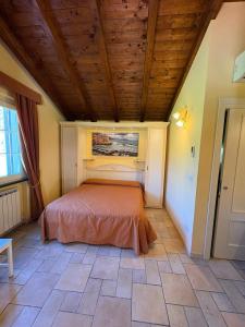a bed in a room with a wooden ceiling at B&B Terra Di Liguria in Casarza Ligure