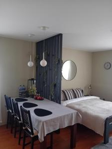 a room with two beds and a table and chairs at Grīvas apartamenti in Ogre +16 photos