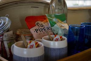 a drawer with three bowls of food and a bottle at Shell Cottage B&B in Toscaig +9 photos