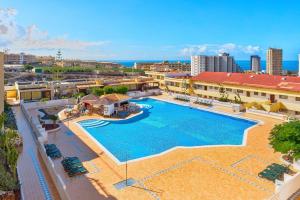 an overhead view of a swimming pool at a resort at Modern 1BR Ocean View with AC and Pool in Costa Adeje by Aqua Vista Tenerife in Adeje