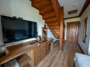 a living room with a large flat screen tv at Hotel Azmakhan in Akyaka