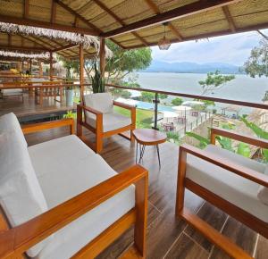 a porch with beds and a view of the ocean at Riosol Laguna Azul in Sauce