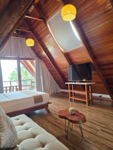 a bedroom with a bed and a tv in a room at Riosol Laguna Azul in Sauce