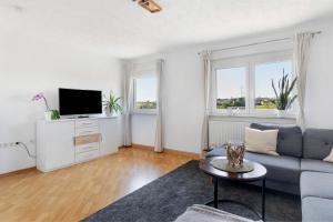 a living room with a couch and a tv at Four Seasons in Krautheim