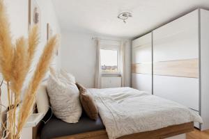 a bedroom with a large bed and a window at Four Seasons in Krautheim