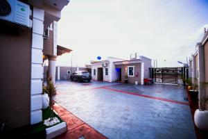 a car parked in a parking lot next to a building at Ralphnest Suite & Lounge Limited in Otta