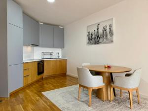 a kitchen and dining room with a table and chairs at Beachfront Rafailovici - Budva in Rafailovici