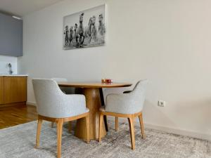 a table and two chairs in a room at Beachfront Rafailovici - Budva in Rafailovici