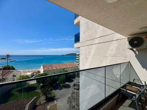 a balcony of a building with a view of the ocean at Beachfront Rafailovici - Budva in Rafailovici +80 photos